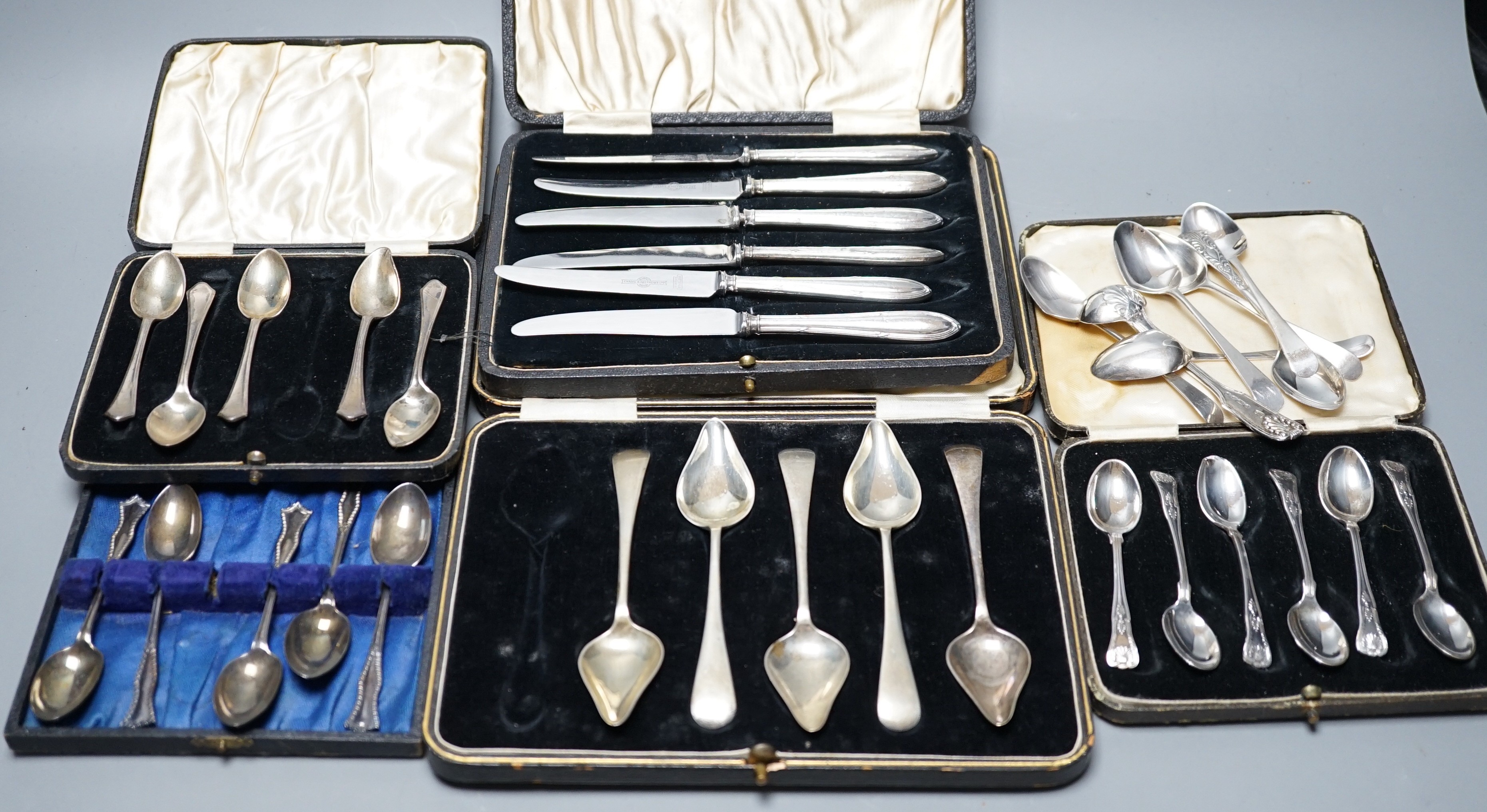 A case set of six George V silver Kings pattern coffee spoons, a cased set of six silver handled cake knives, three other incomplete silver sets and other minor silver flatware.